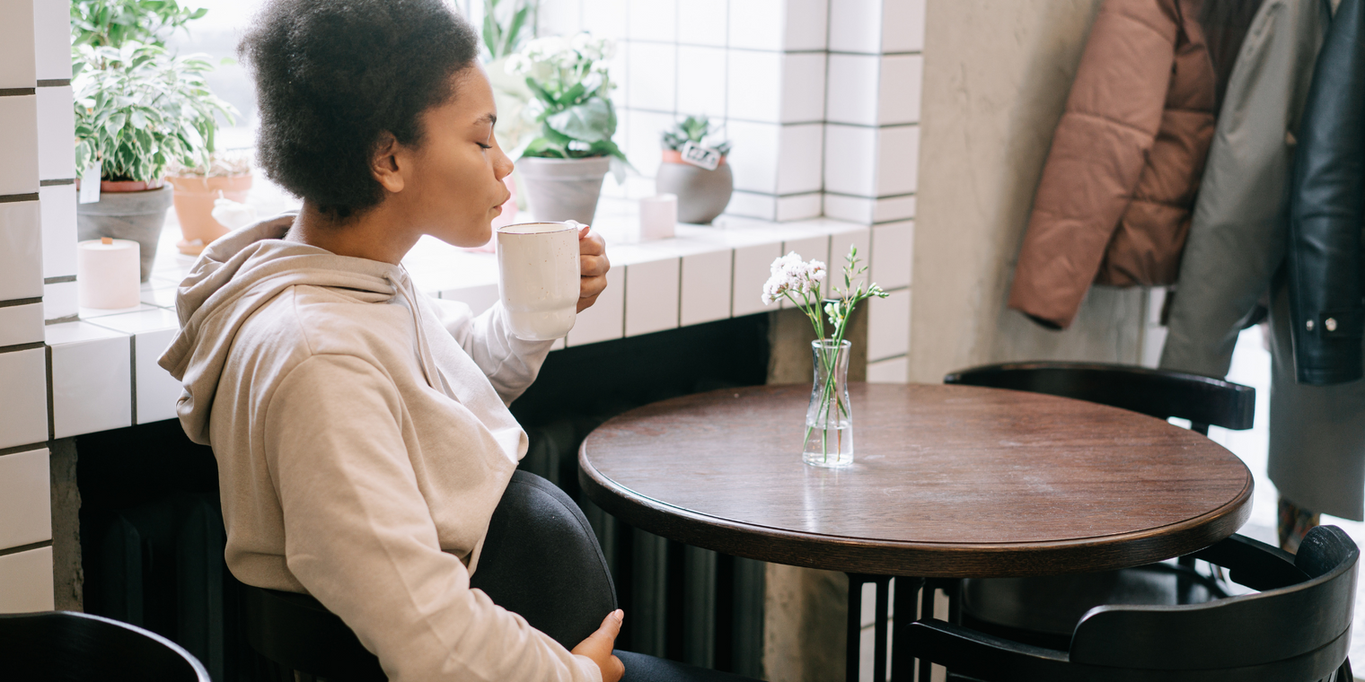 pregnant woman drinking coffee